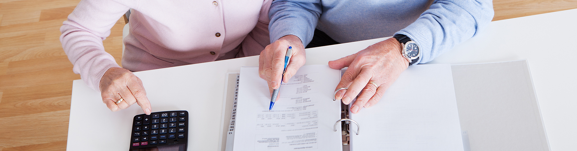 Home care couple doing paperwork - 1900x500