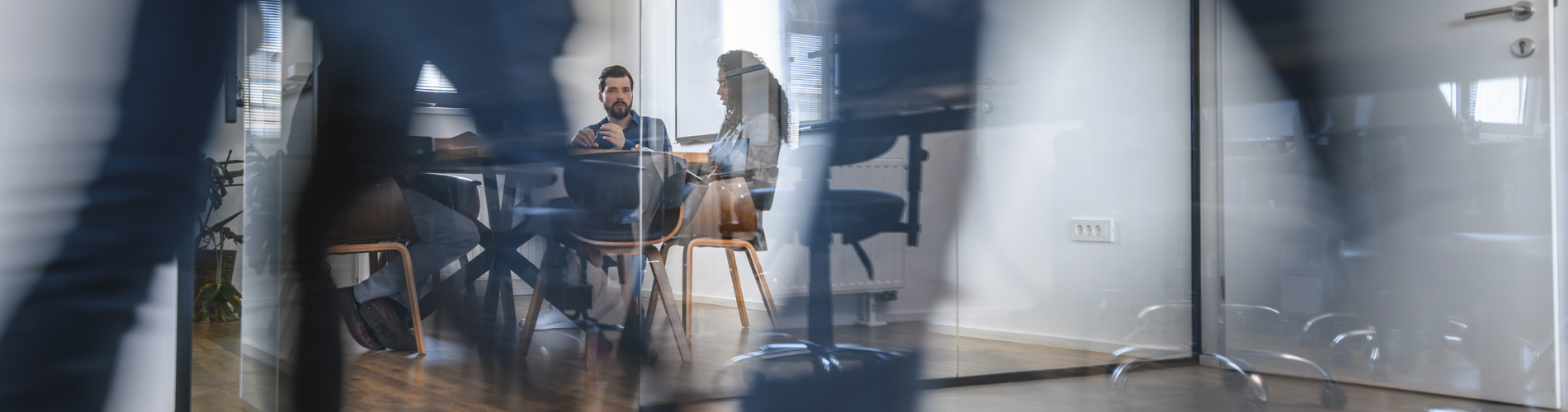 Workplace, people walking past meeting 1900x500