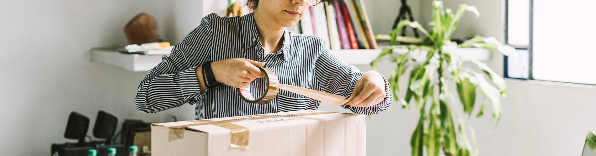 Young woman packing a box 1900x500