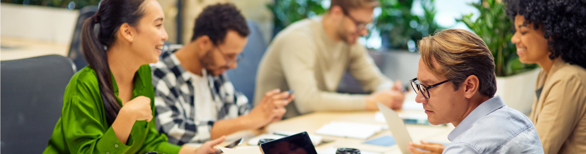 business-meeting-group-of-multiracial-people-sitting-at-the-desk-in-the-modern-coworking 1900x500