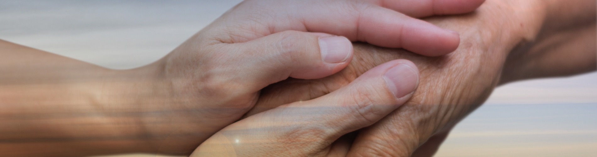 caregiver-carer-hand-holding-elder-hand-in-hospice-care-with-sky-sunset-background-euthanasia 1900x500