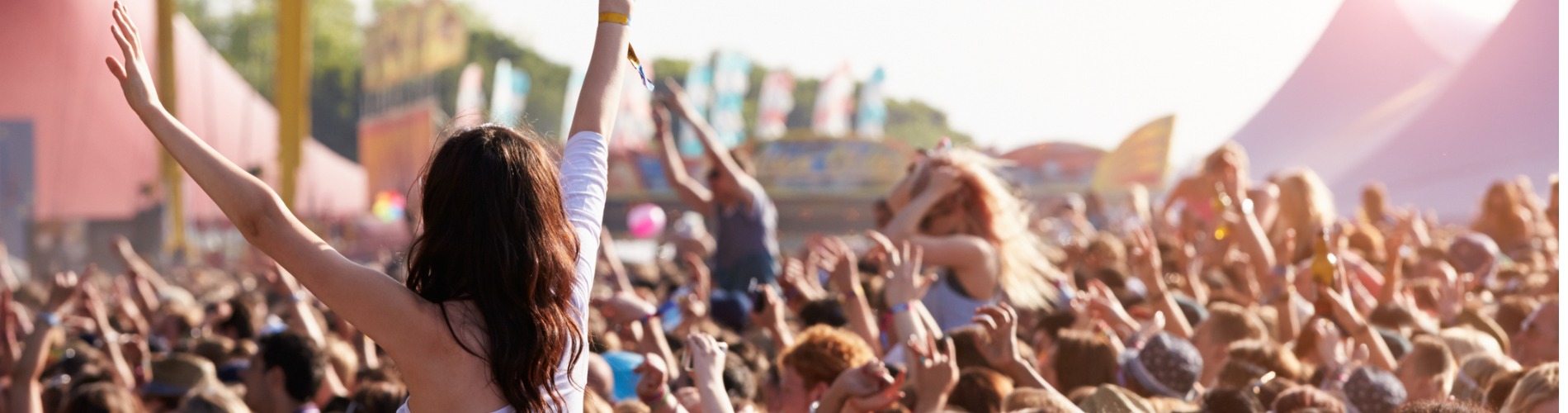 people-with-their-arms-in-air-at-music-festival 1900x500