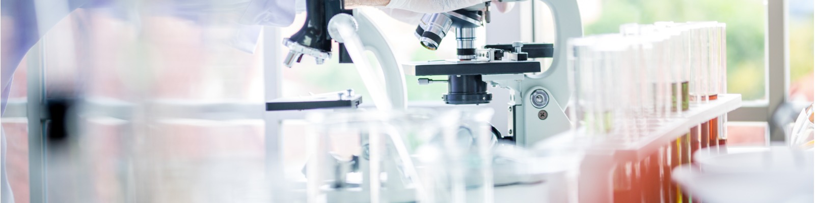 scientists-man-working-and-look-in-to-microscope-in-lab-picture-1600x400