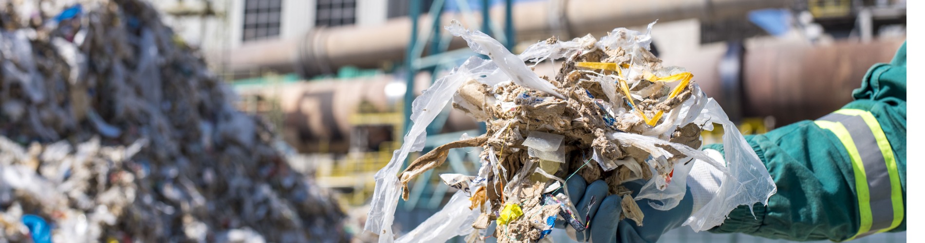 selective-focus-shot-of-a-person-wearing-gloves-holding-shredded-municipal-waste 1900x500