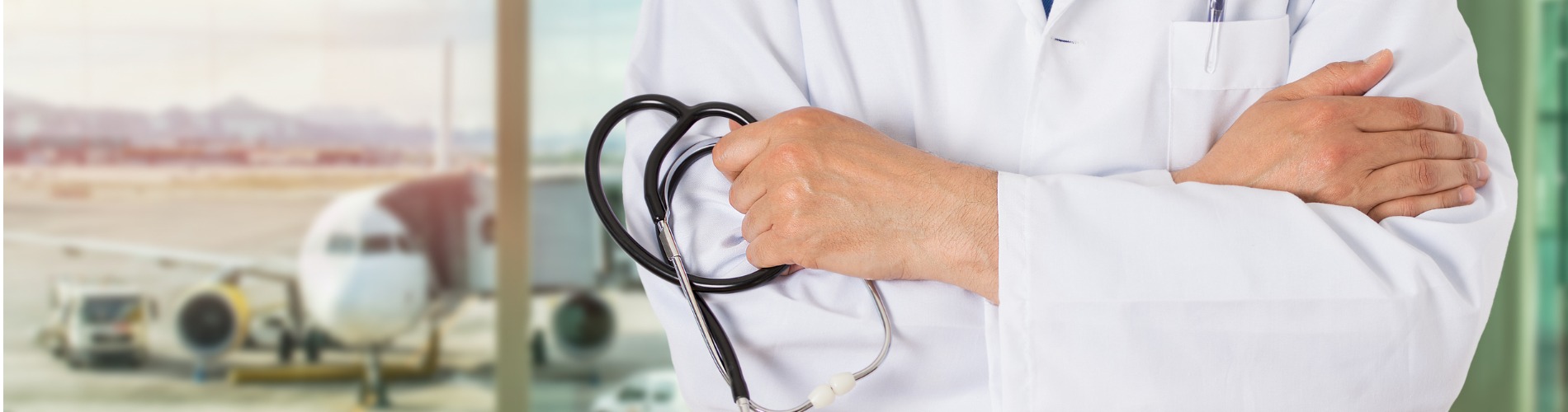 unrecognizable-male-doctor-standing-with-his-arms-folded-inside-of-a-airport 