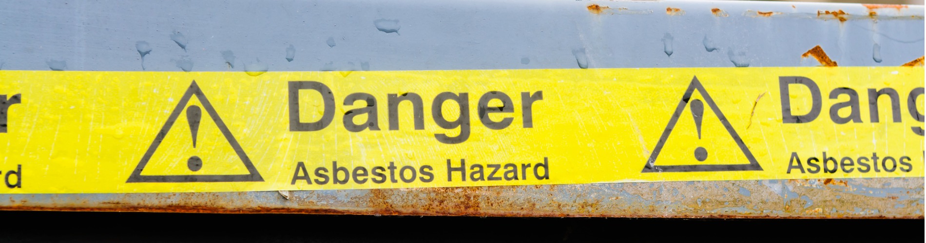 warning-tape-across-a-bin-at-an-asbestos-clean-up.jpg-1900x500