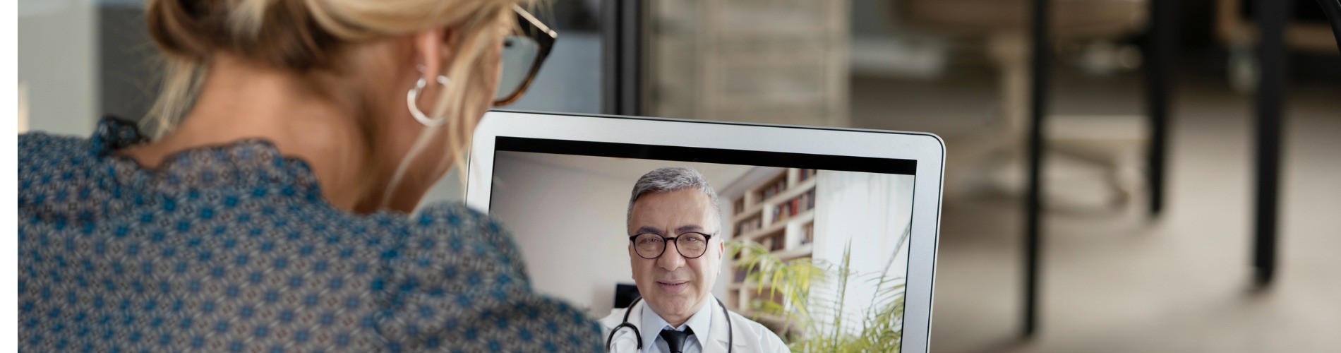 young-woman-talking-with-doctor-on-digital-tablet 1900x500